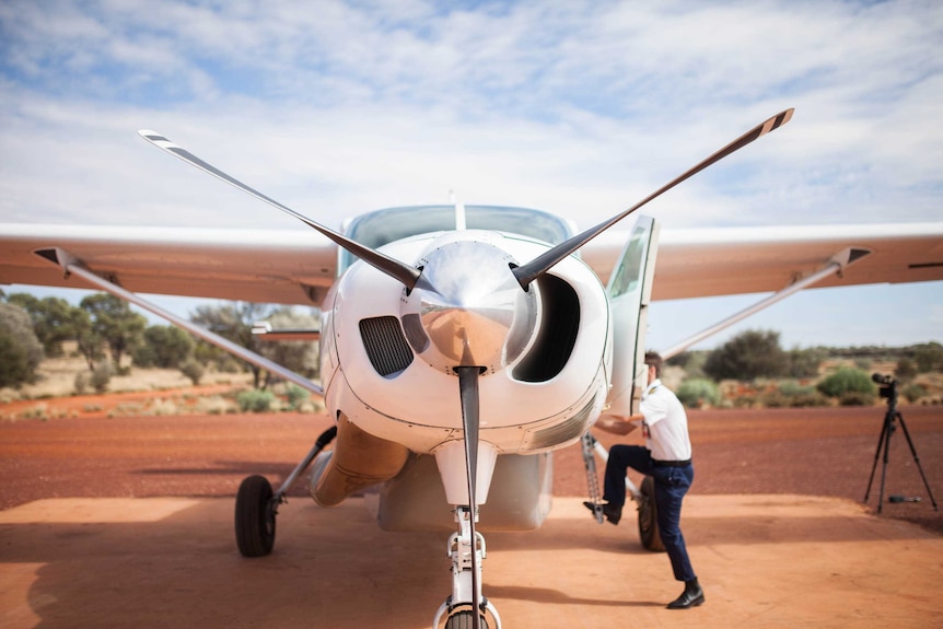 Pilot Harvey Salameh climbs into his plane in remote WA.