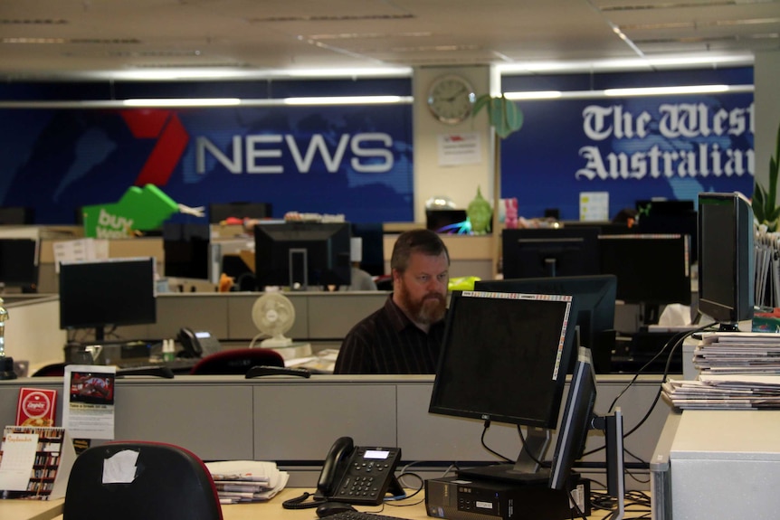 A journalist at work in the Seven West media newsroom.