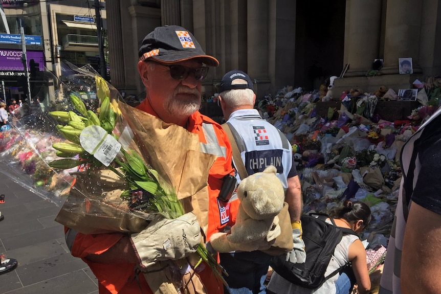 Flowers are removed from a make-shift memorial