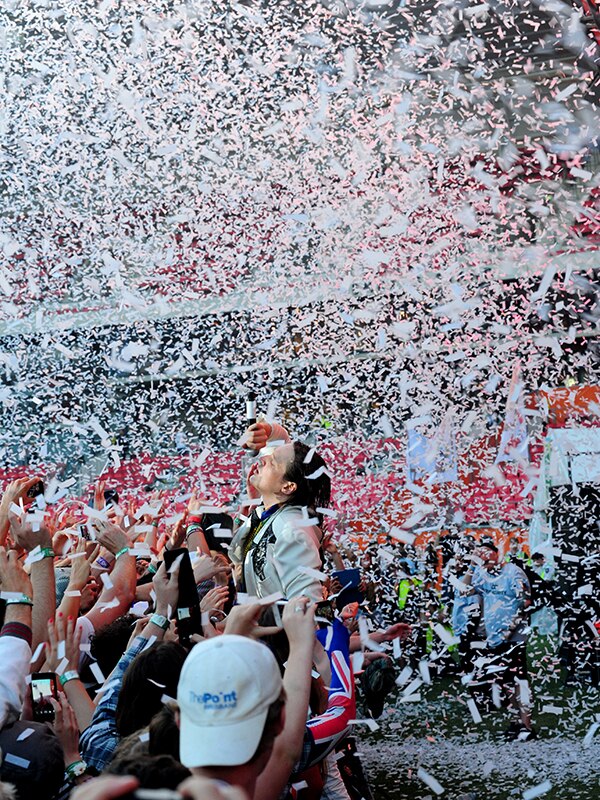 Win Butler of Arcade Fire jumps into the crowd at the 2014 Big Day Out as confetti flies around him