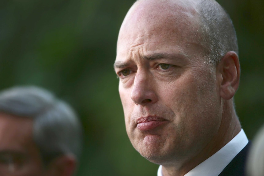 A tight head shot of Dean Nalder speaking at a media conference.