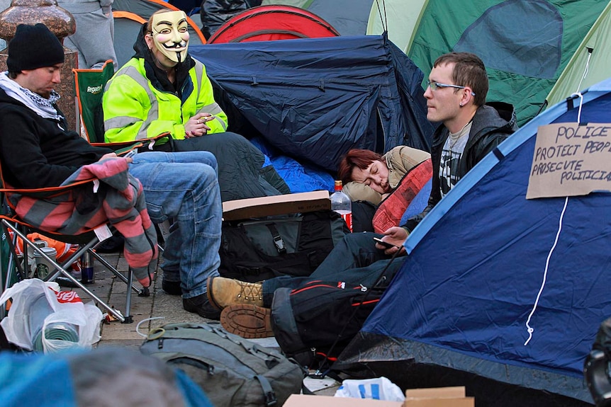 Demonstrators sit in their camp outside St Paul's Cathedral in central London on October 16, 2011.