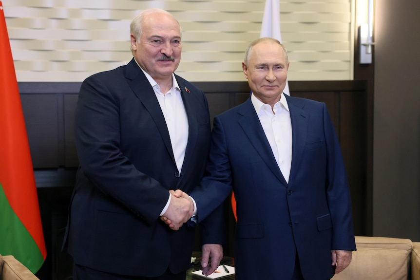 Russian President Vladimir Putin, right, and Belarusian President Alexander Lukashenko shake hands. 