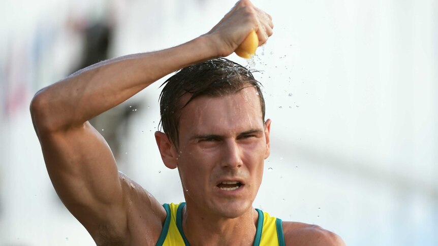 Dane Bird-Smith of Australia sponges himself with water during the Men's 20km Race Walk