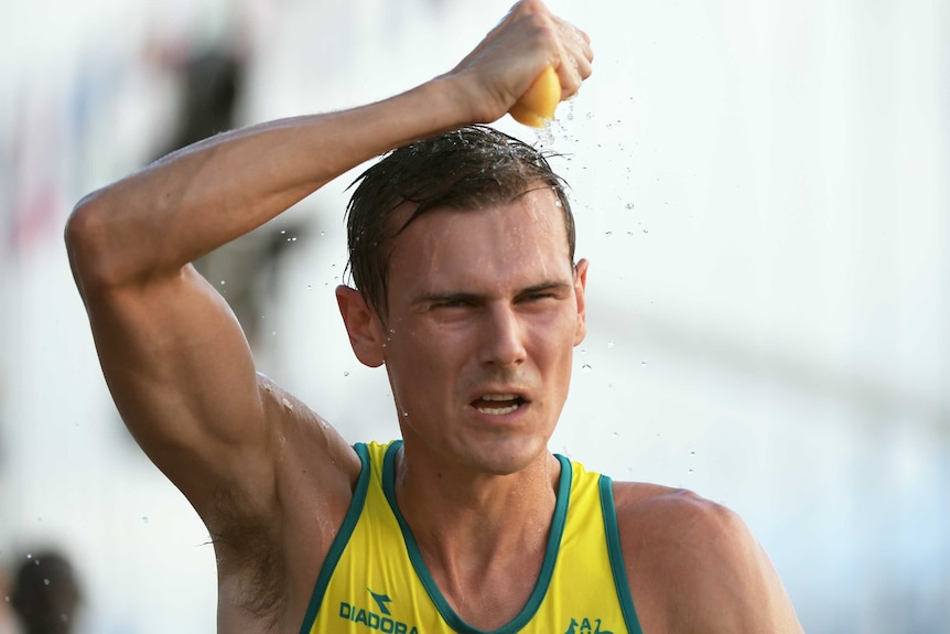 Dane Bird-Smith of Australia sponges himself with water during the Men's 20km Race Walk