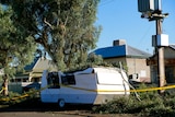 A white caravan crushed by falling trees in Broken Hill. 
