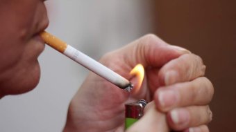 Close-up of a person lighting a cigarette