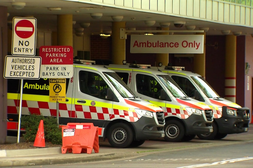 a row of ambulances outside a hospital