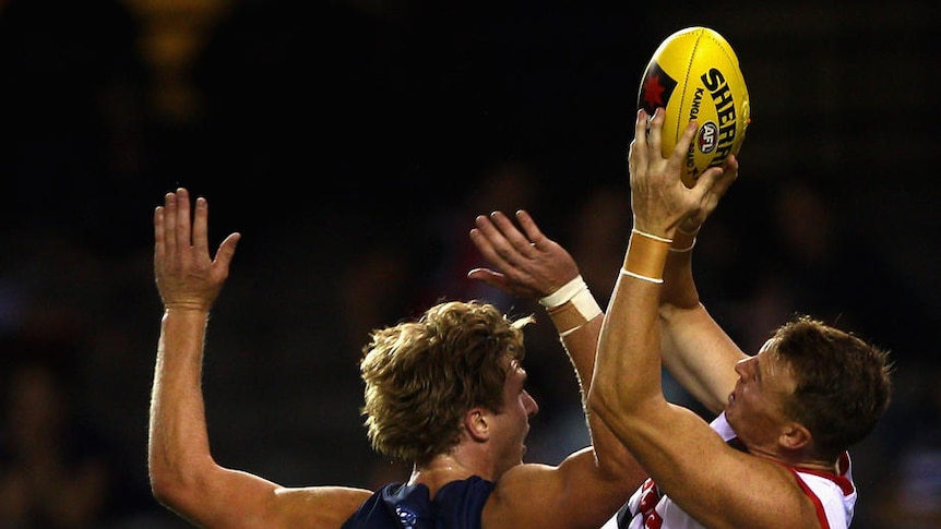 St Kilda's Brendon Goddard soars high to mark over Geelong's Dawson Simpson at Docklands.