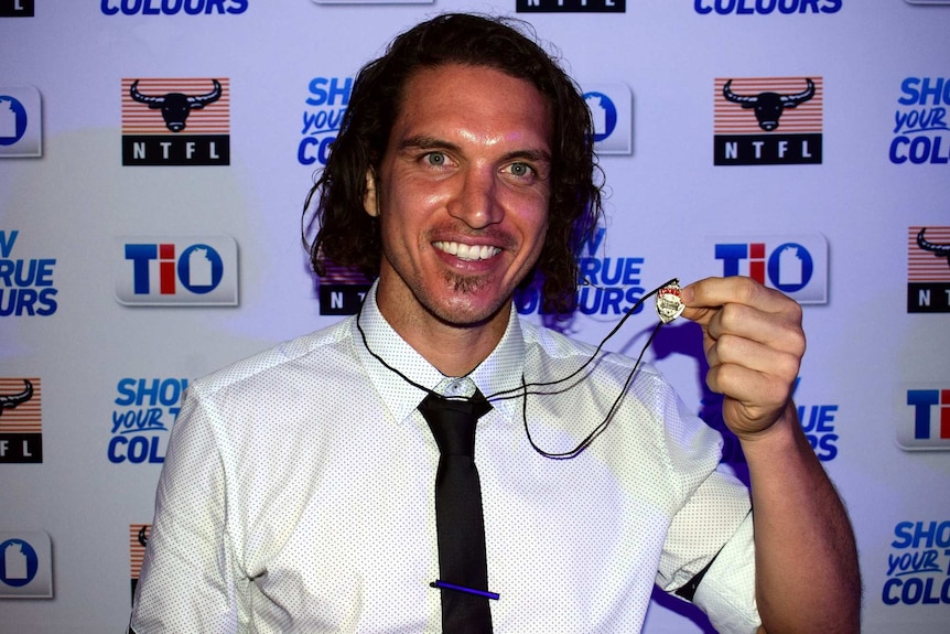 Cameron Ilett smiles wearing the Nichols Medal around his neck.