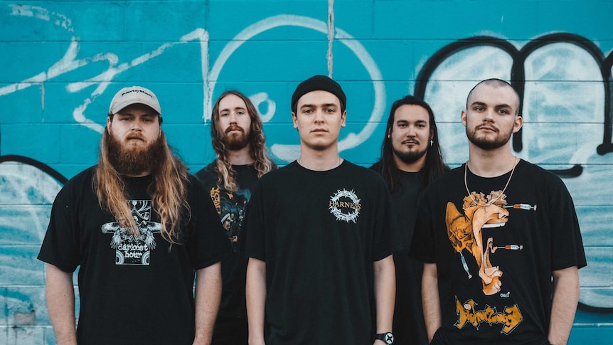 band knocked loose standing in front of a wall