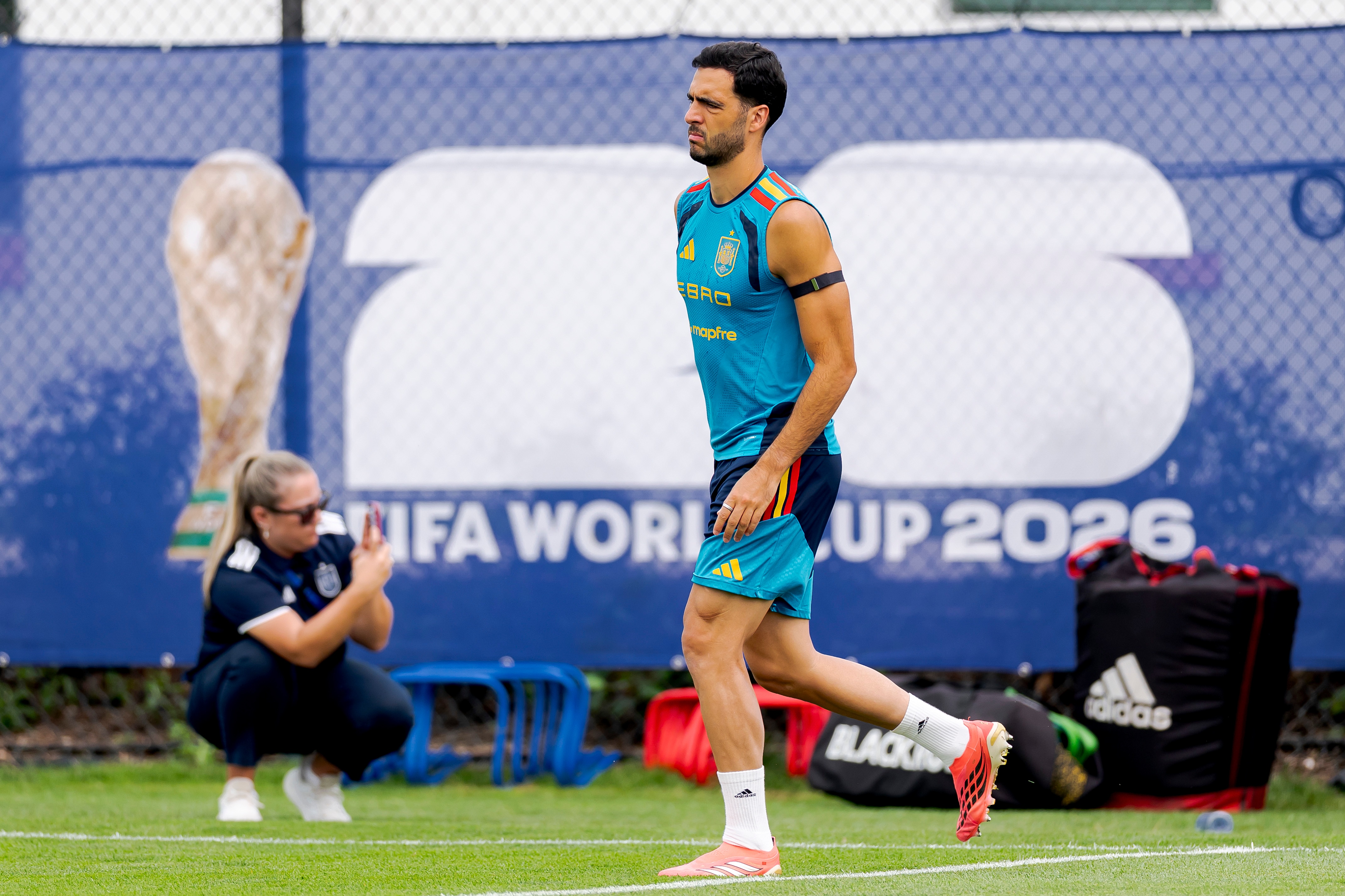 A football player stretches at a training session.