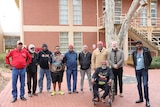 A group of Warlpiri men gathered outside the South Australian Museum. 