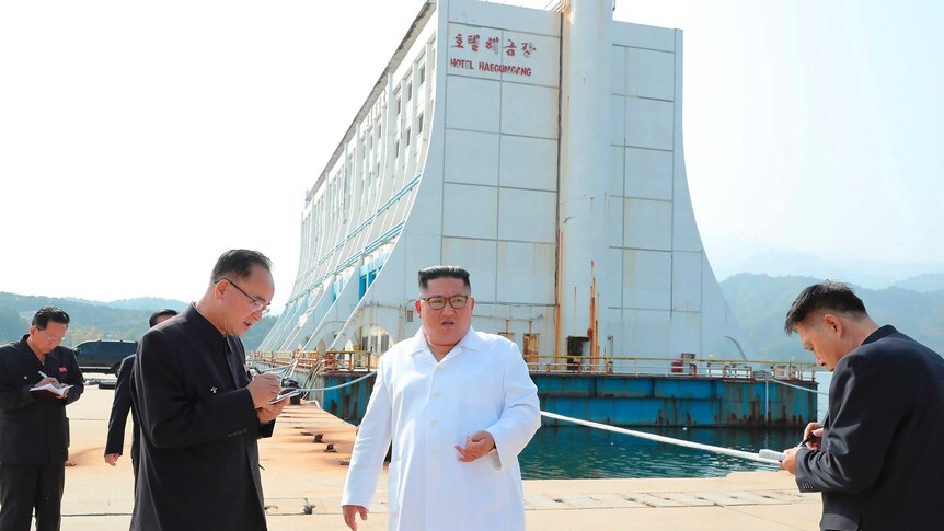 Kim Jong-un stands in front of Hotel Haegumgang, the former floating Barrier Reef Resort from Townsville, at a dock.