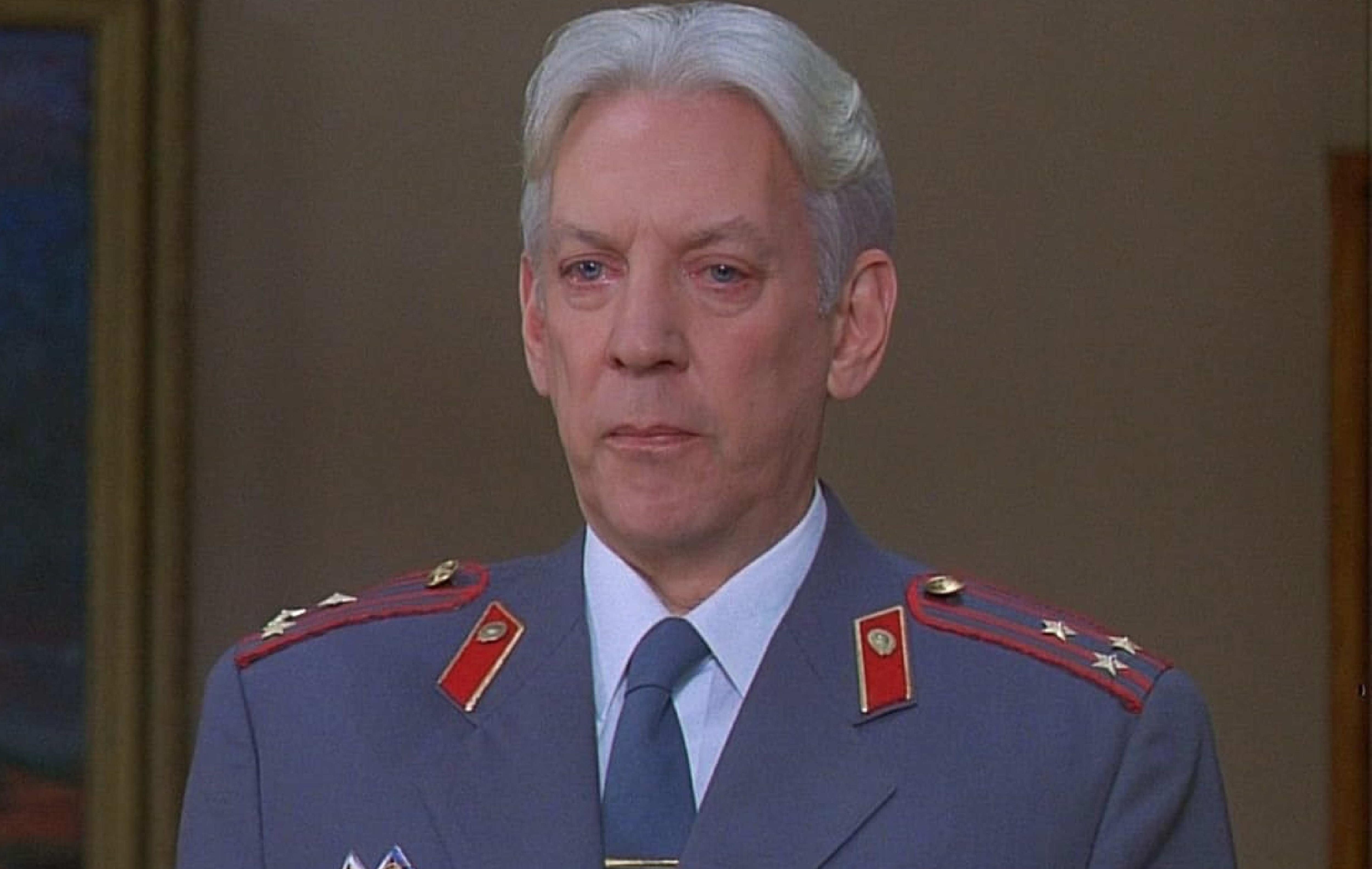 Donald Sutherland in a blue and red commander type uniform in the film Citizen X