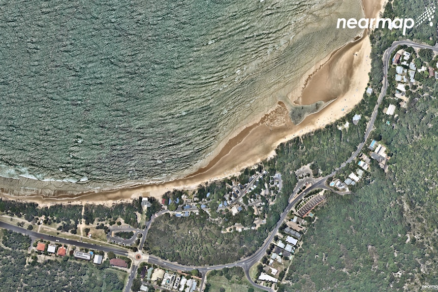 An aerial image of the main beach and Clarkes Beach at Byron Bay shows higher water tides and less sand along the beach.