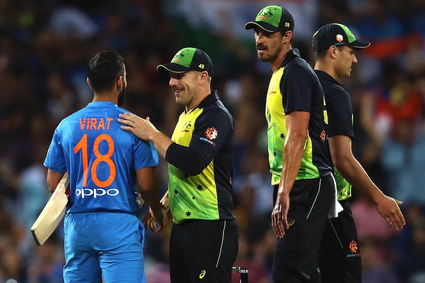 Aaron Finch smiles as he shakes hands with Virat Kohli after India beat Australia in the SCG T20 international.