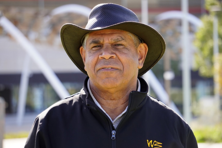 Headshot of a man wearing a hat