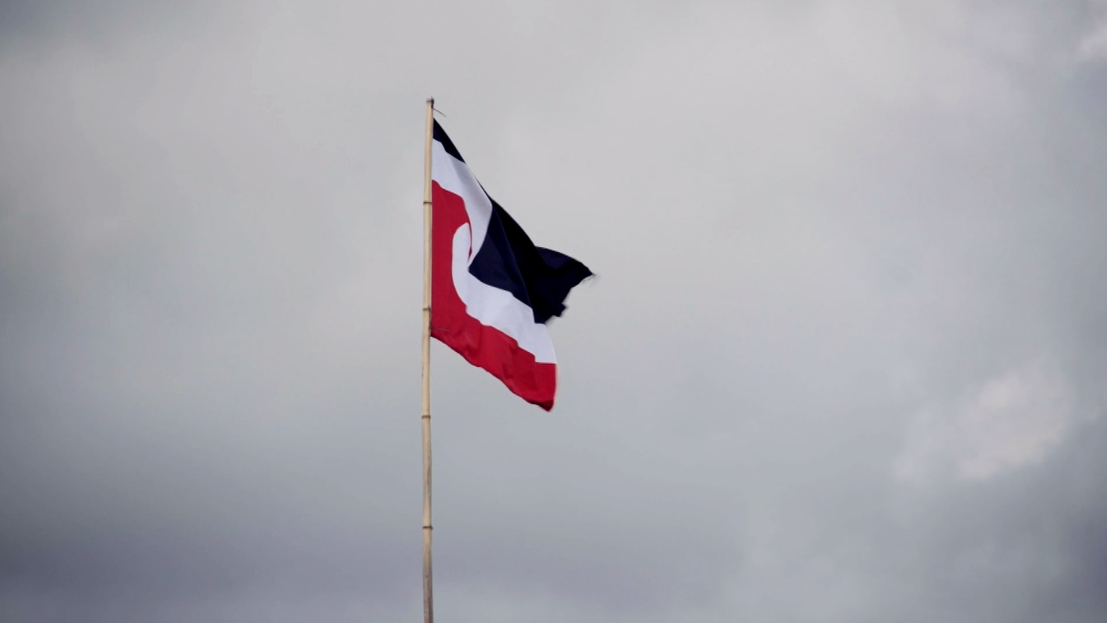 A Māori flag featuring red, black and white designs.