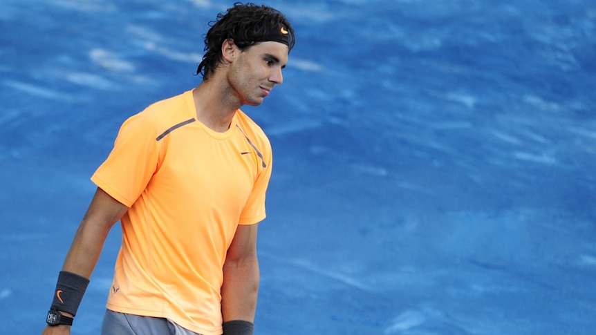 Grouchy smurf: Nadal continued to show his displeasure with the slippery, blue clay in Madrid.