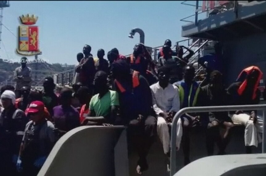 Refugees on the deck of a ship in harbour in Sicily on July 20, 2014.