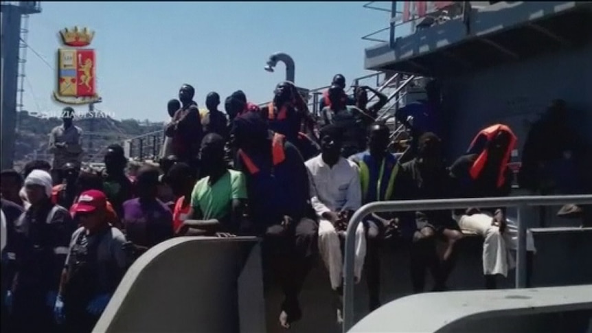 Refugees on the deck of a ship in harbour in Sicily on July 20, 2014.