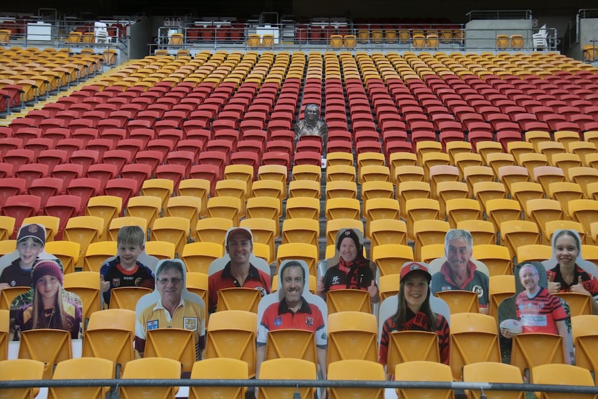 Cut out pictures of fans and Wally Lewis fill empty seats in a stadium.