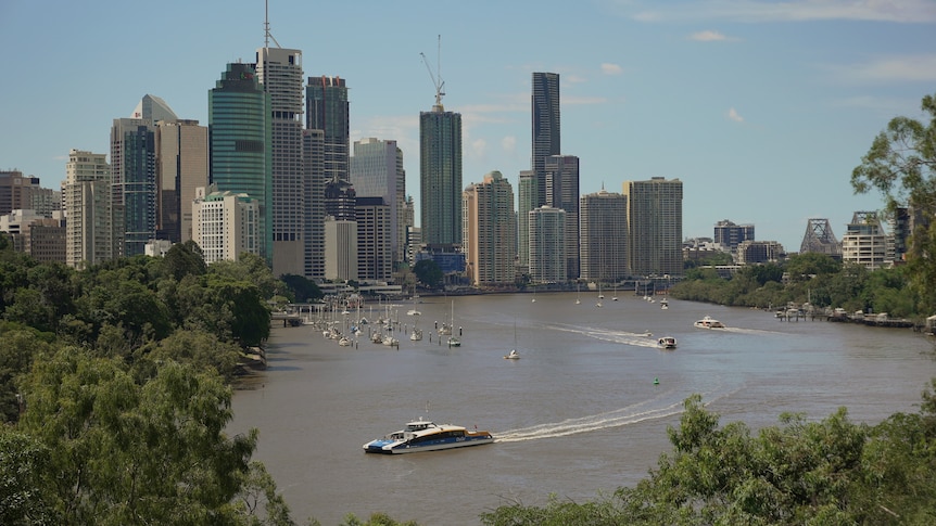 Brisbane CBD with CityCat in Brisbane River