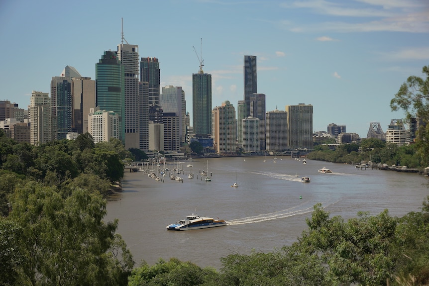 Brisbane CBD with CityCat in Brisbane River