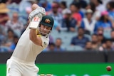 Australia batsman Shaun Marsh plays a powerful off drive during a Test against India at the MCG.