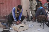 Fighters from the former Al-Nusra Front prepare their weapons after they recaptured military academies south of Aleppo, Syria.