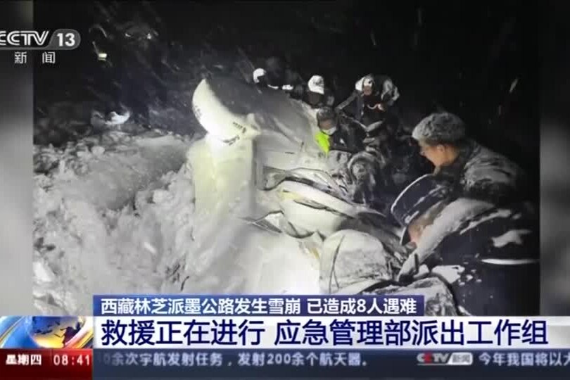 Rescuers search for survivors in snow.