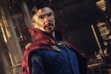 Goateed superhero Doctor Strange, wearing a cape, looks concerned about something out of shot.