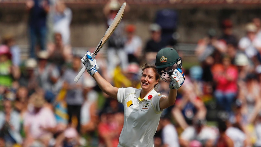 Ellyse Perry runs with her bat in her right hand and helmet in her left after she scored a century against England.