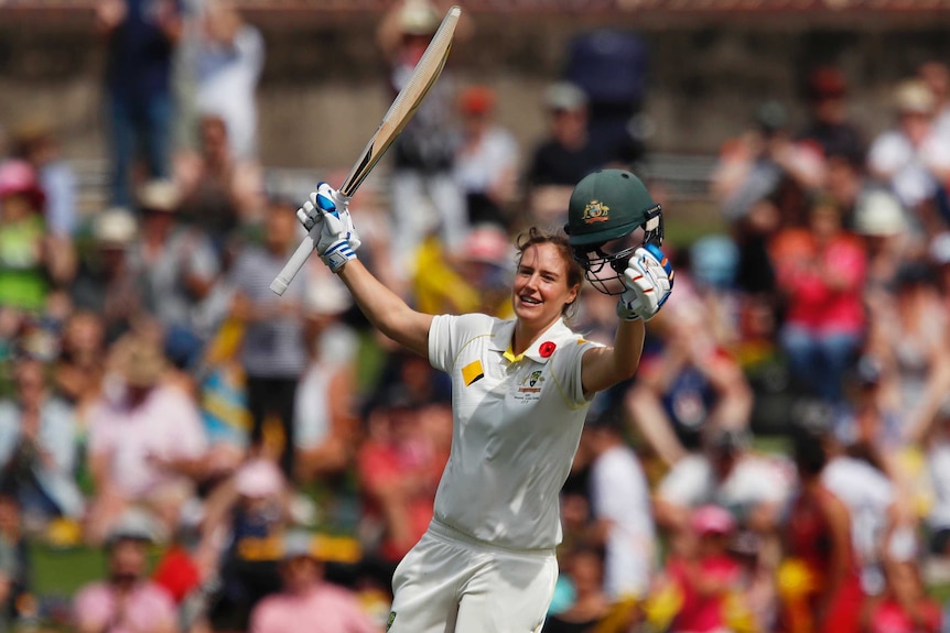 Ellyse Perry runs with her bat in her right hand and helmet in her left after she scored a century against England.