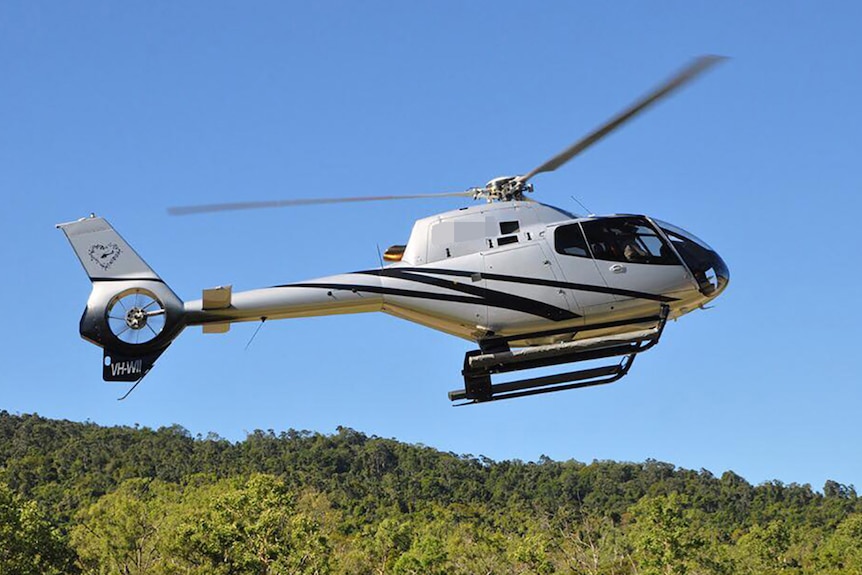 A helicopter in flight close to the ground