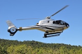 A helicopter in flight close to the ground