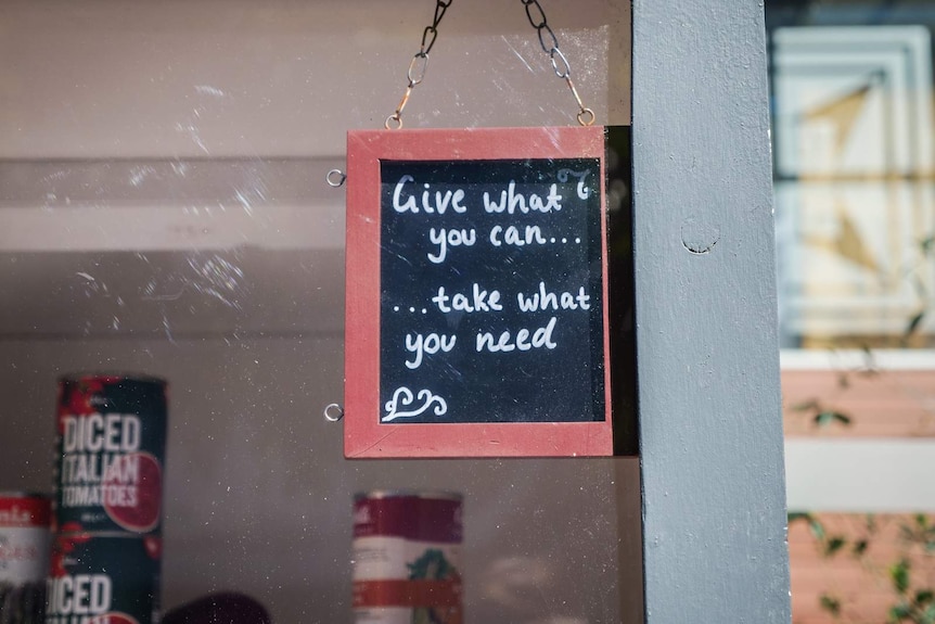 A small sign on a cupboard door.