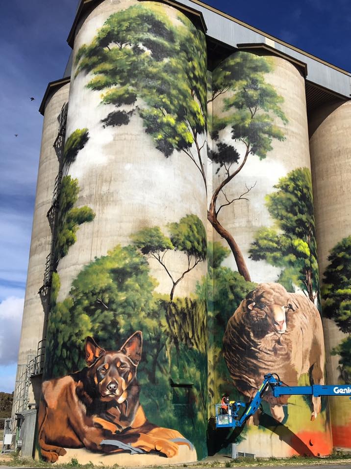 big silos with colourful paintings on them