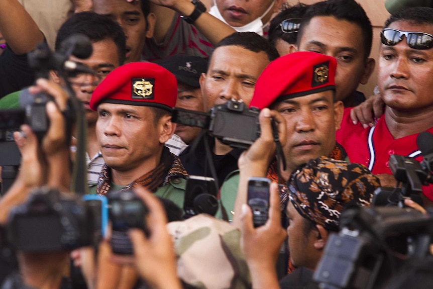 Ucok Tigor Simbolon and Sugeng Sumaryanto leave court after receiving their sentence.