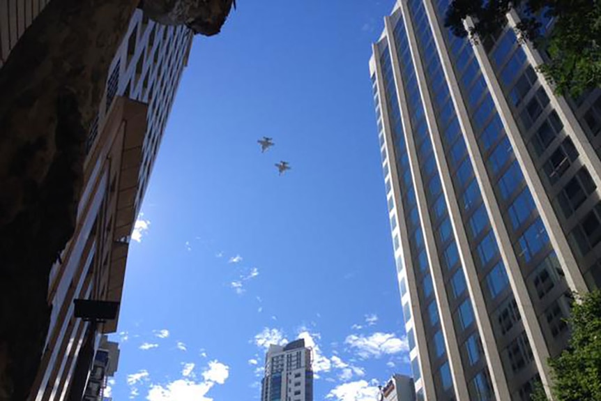 Super Hornets from Amberley Air Base fly over the Brisbane Anzac Day march
