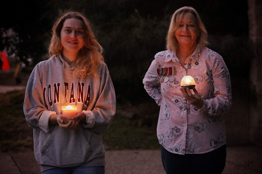 Residents lighting up the dawn outside their home in Yeronga