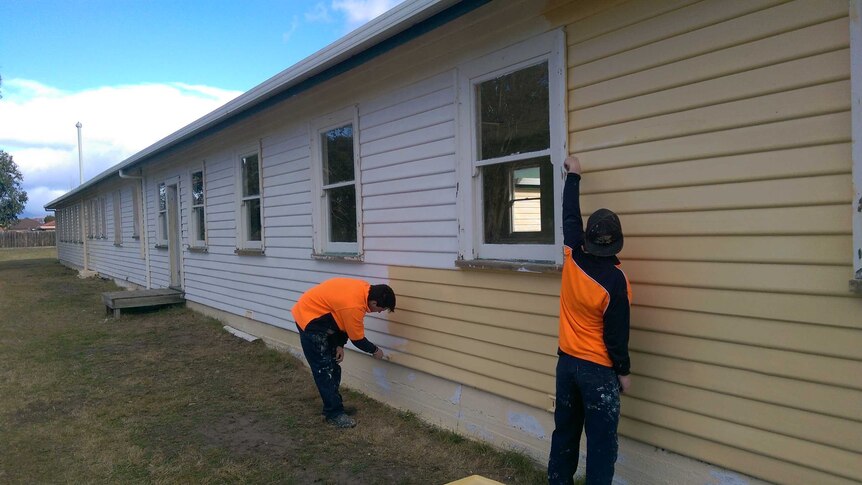 Tasmanian heritage building restoration project; two trainees paint a building at the old Brighton Army Hospital.