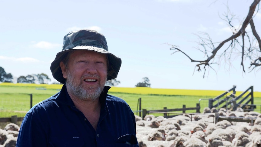 Farmer Lloyd Berry standing in front of his sheep