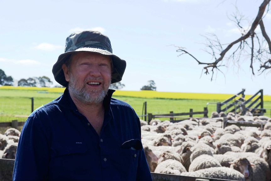 Farmer Lloyd Berry standing in front of his sheep
