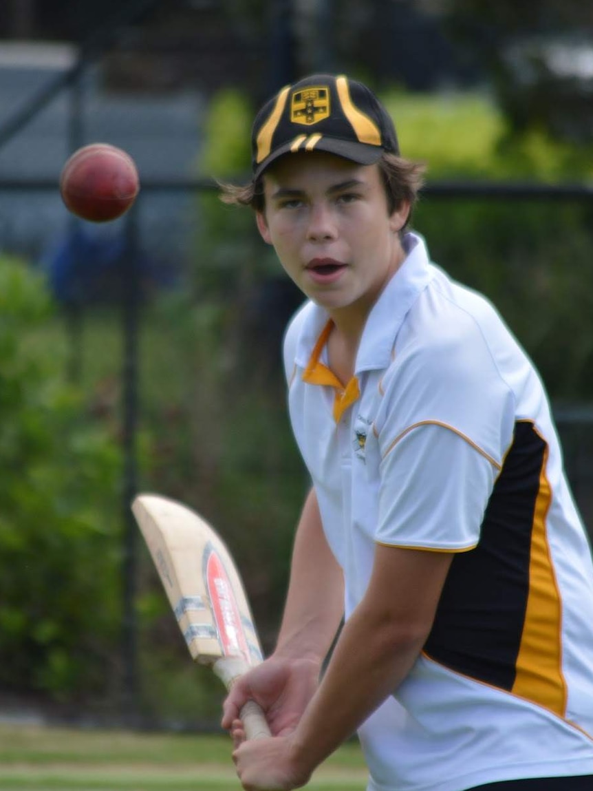 Cooper lifts his cricket bat to hit the ball