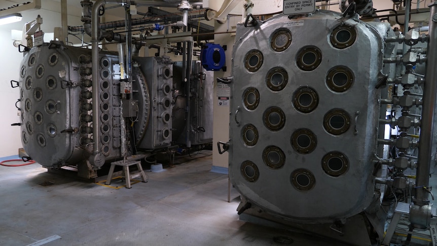 Two large silver machines covered in small circle windows.