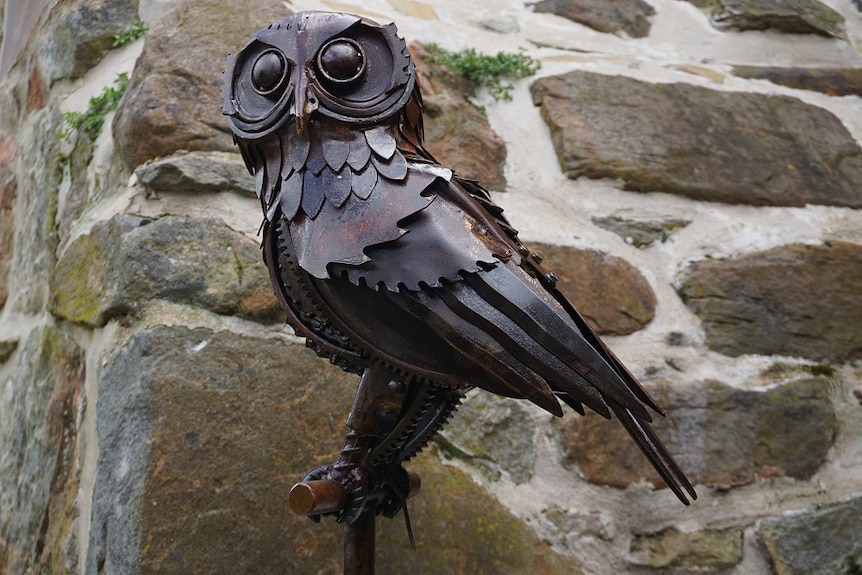 A Southern Boo Boo Owl made from scrap metal looks at the camera