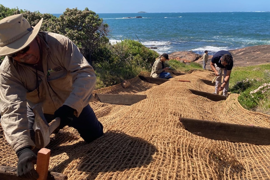 Workers adding a protective layer to the surface.