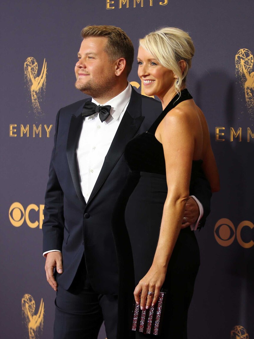 Actor and television host James Corden and his wife Julia Carey both wearing black.